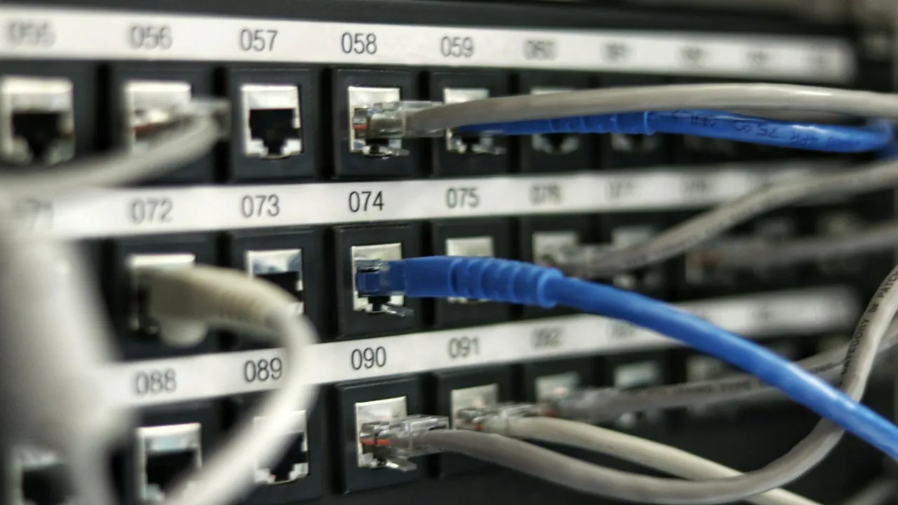 Close-up of a computer workstation showing connected Ethernet cable and keyboard