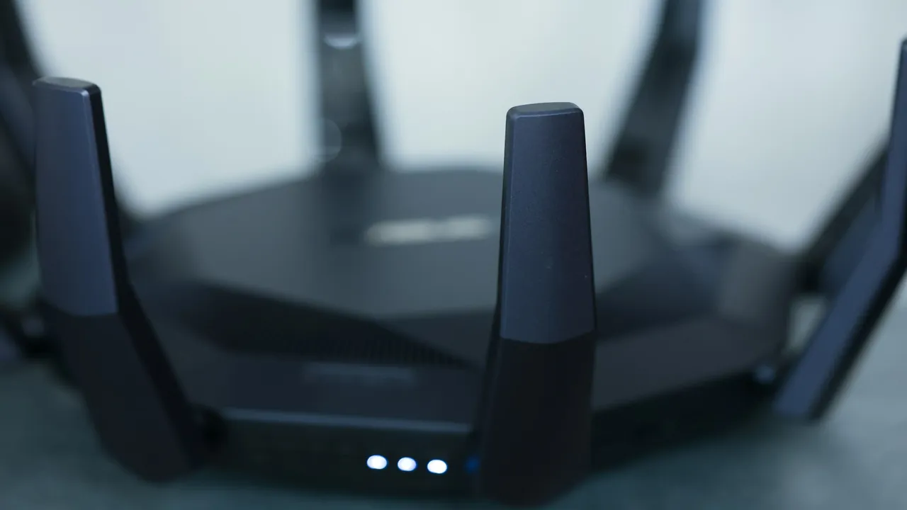 Hand carefully adjusting the antenna angle on a wireless router